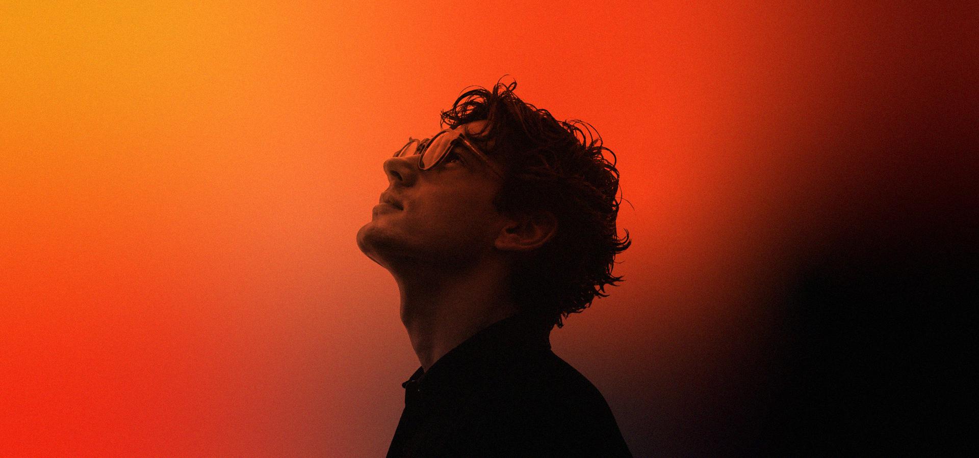 A young man looking out, mid-thought